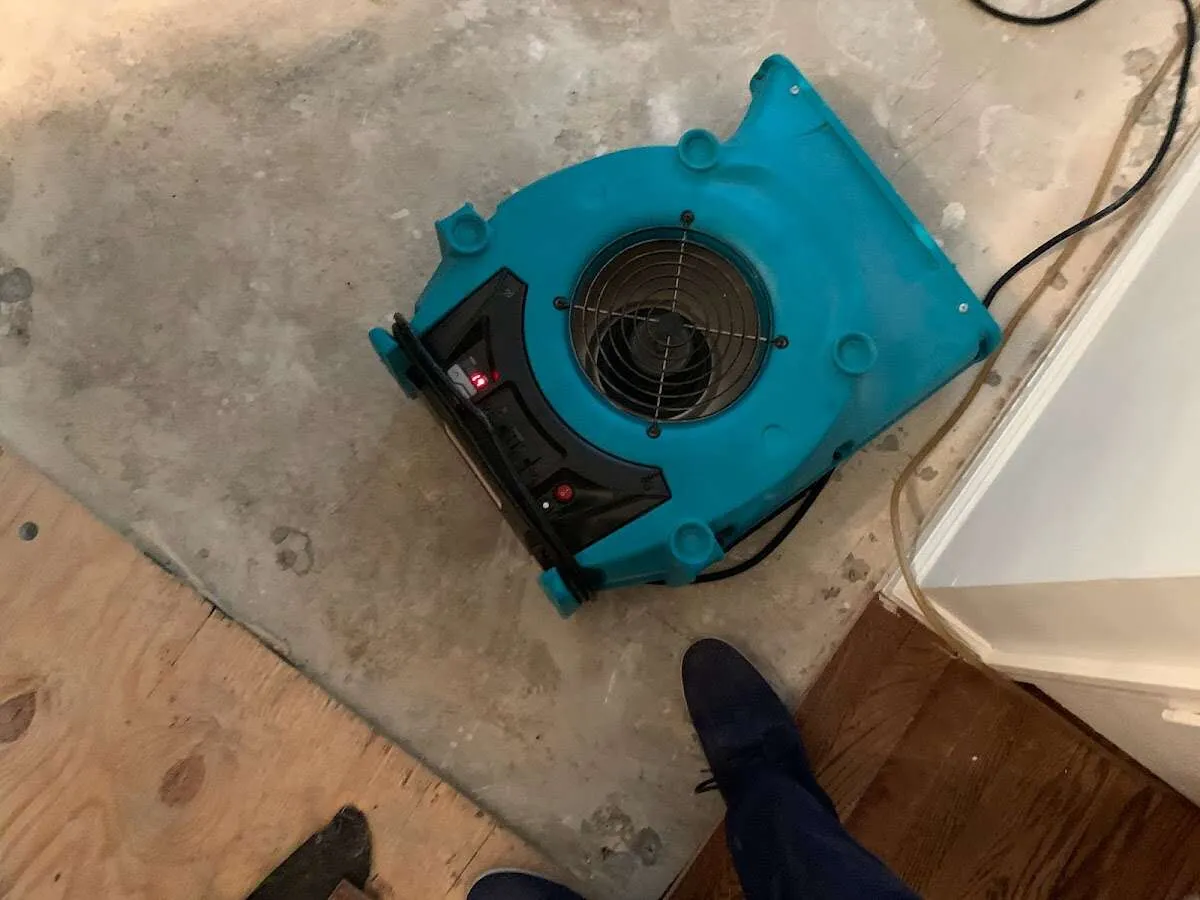 Air mover drying subfloor during Commercial Water Damage Restoration in Wellston